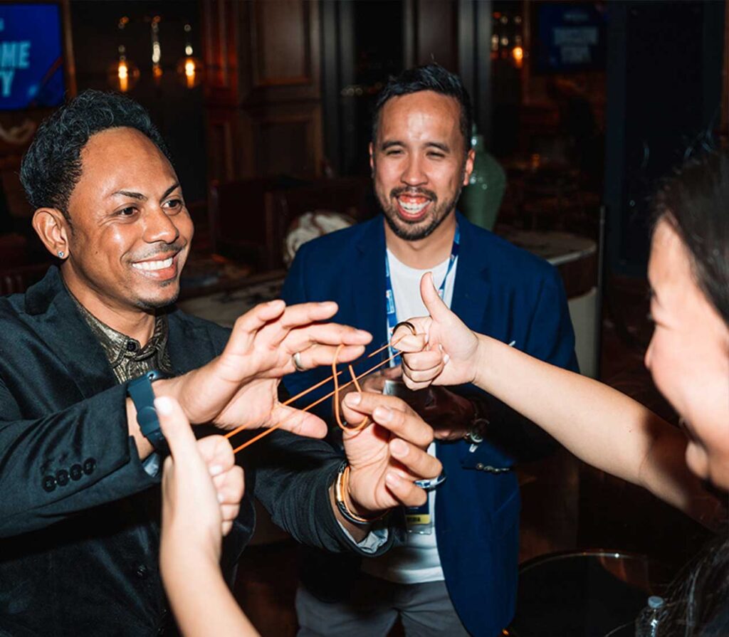 Magician Chris Workman does strolling magic to guests at a company event