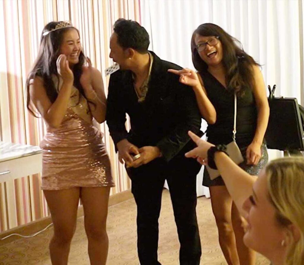 las vegas strolling magician chris workman performing close-up card magic to few girls in a hotel room party