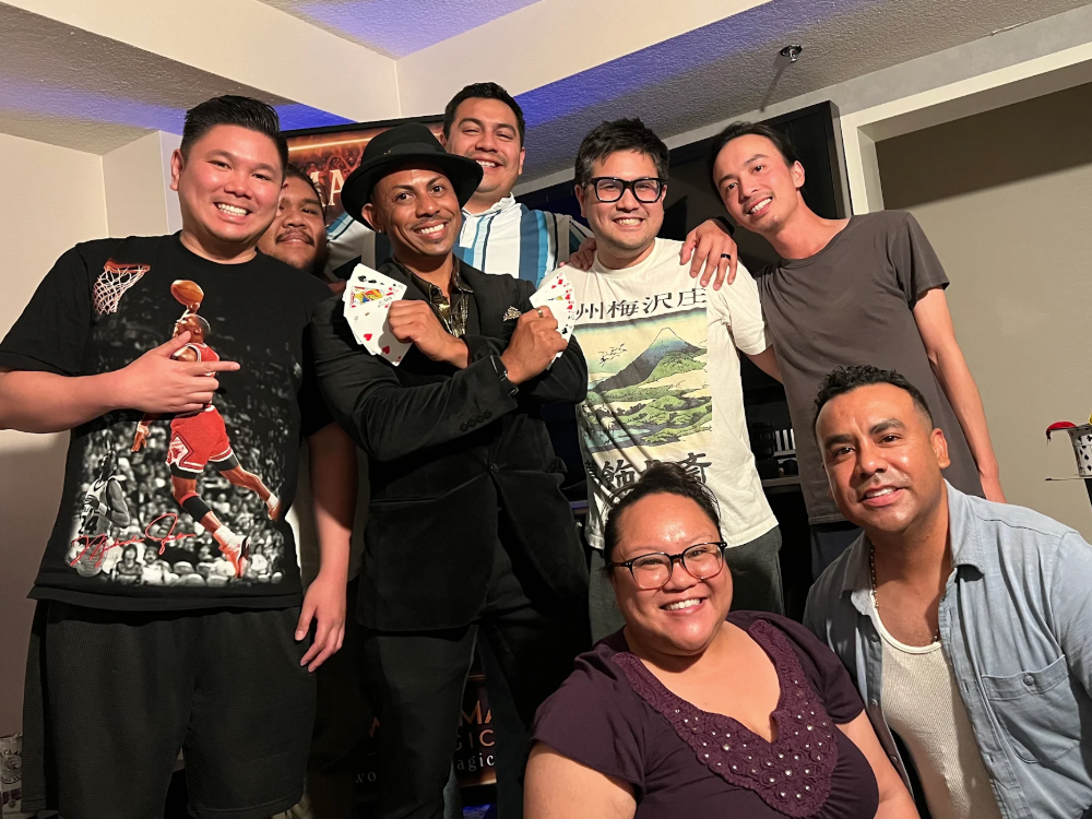 group of guys surrounding las vegas magician chris workman after a bachelor party magic show