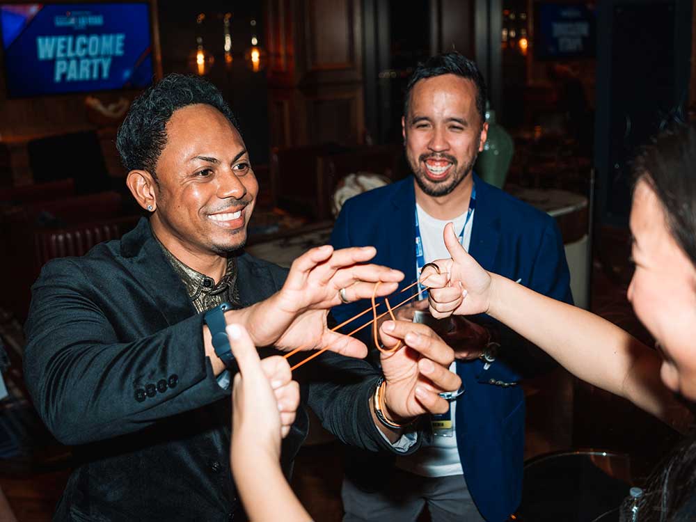 Magician Chris Workman does strolling magic to guests at a company event